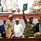 Sudan's protest leader Ahmad Rabie (R), flashes the victory gesture alongside General Abdel Fattah al-Burhan (2nd-R), the chief of the military council, after signing the "constitutional declaration" on Saturday