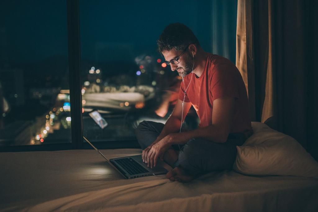 Man working in the bedroom at night