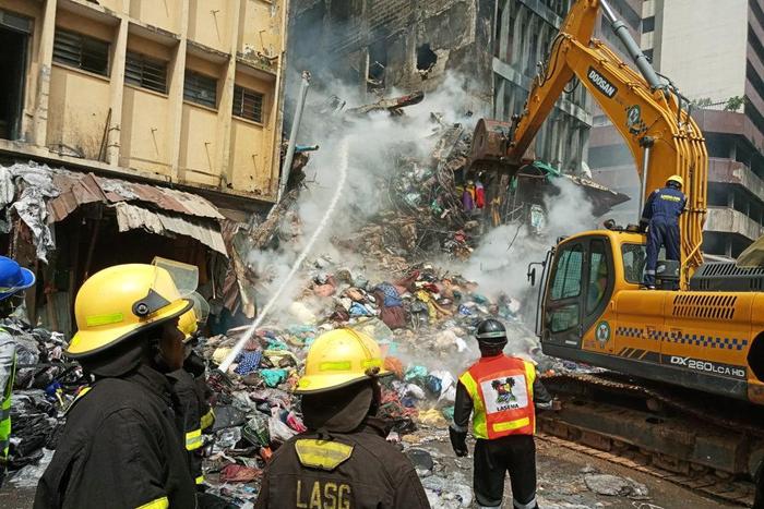 Men of Lagos State Fire Service and other emergency officials at the scene of the fire disaster at Mertins Street, Lagos on Wednesday (NAN)