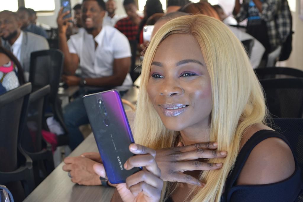 Isilomo, capturing the prizegiving ceremony with her OPPO F11 Pro at the OPPO Head Office today