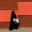 An Afghan woman holds election posters for Abdullah Abdullah -- the current chief executive officer and one of the front-runners