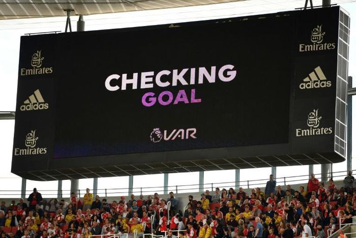 A scoreboard shows that VAR is checking a possible goal