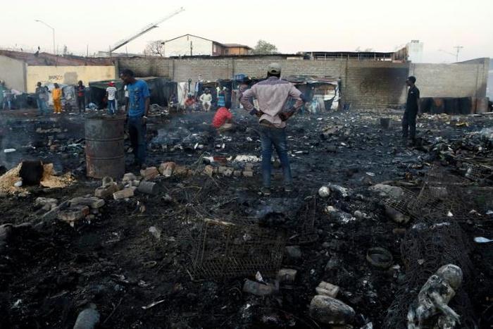 Foreigners in Marabastad, in the Pretoria area, try to save their belongings after their shacks were set alight in last month's attacks