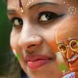 Britain will commission a commemorative coin to mark the 90th anniversary of the final visit by Indian independence hero Mahatma Gandhi; a girl poses for a picture, August 15, 2019, with her face painted depicting a portrait of Mahatma Gandhi