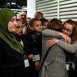 Host families and volunteers greeted the new arrivals -- some of them family members -- with smiles and tears