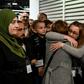 Host families and volunteers greeted the new arrivals -- some of them family members -- with smiles and tears