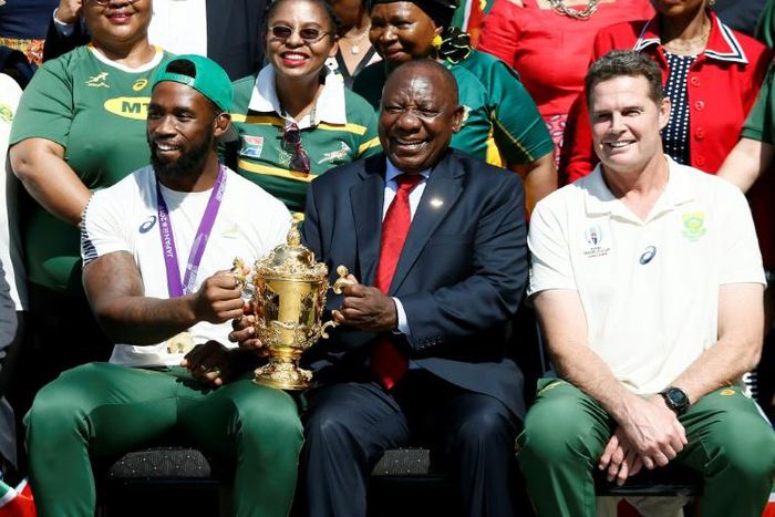 South African President Cyril Ramaphosa holds the Rugby World Cup trophy with Springboks captain Siya Kolisi