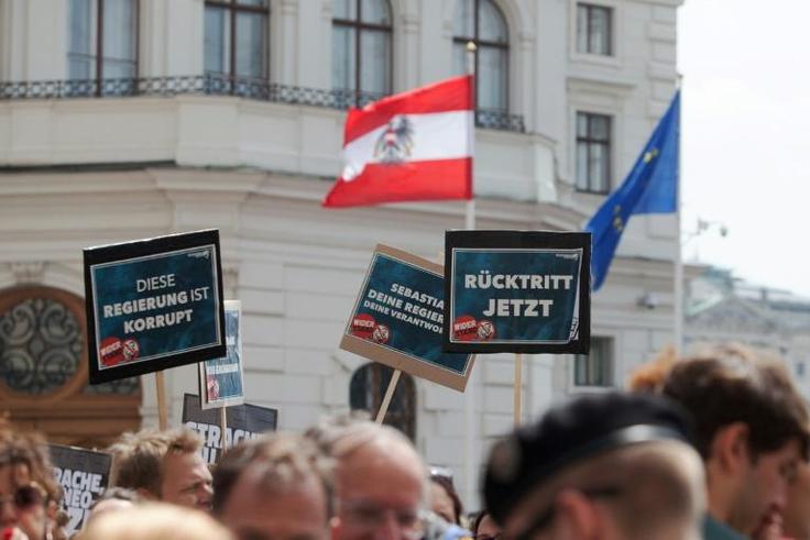 The Ibiza-gate scandal brought down the OeVP-FPOe coalition in May. Here, protesters' signs read "This government is corrupt"