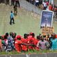 A man holds a sign reading "Alpha Conde dictator" during Thursday's protests