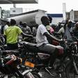 Motorcycle riders in Port-au-Prince, Haiti, wait in line to buy gasoline which is in increasingly short supply