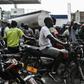 Motorcycle riders in Port-au-Prince, Haiti, wait in line to buy gasoline which is in increasingly short supply