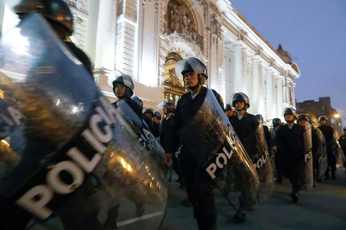 Riot police move into position around the Congress building in Lima after President Martin Vizcarra announced he was dissolving the opposition-dominated legislature