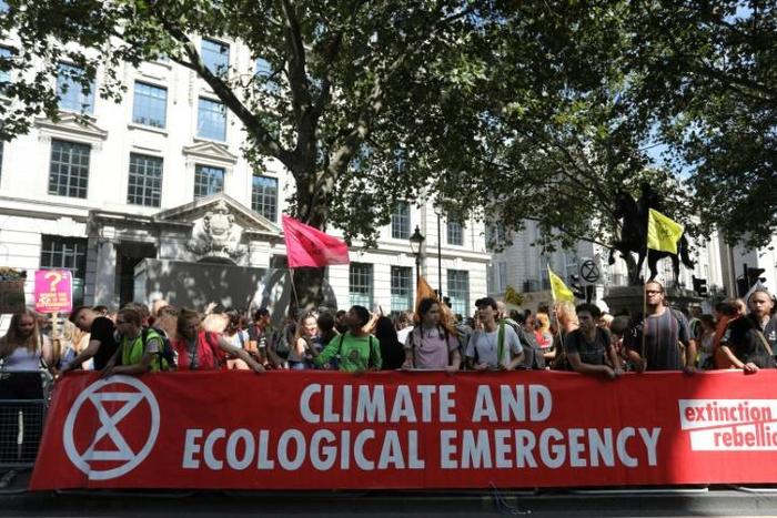 Protesters with placards gather for a demonstration organised by climate change activists from Extinction Rebellion outside the Brazilian embassy in central London on August 23, 2019 calling on Brazil to act to protect the Amazon rainforest from defore...