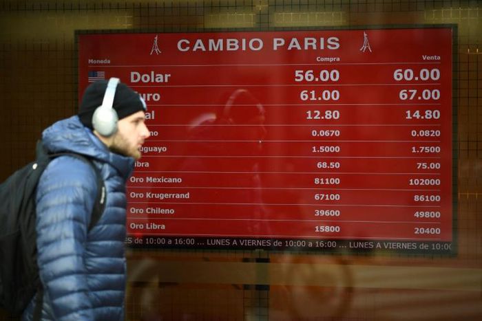 Currency exchange values are displayed on the buy-sell board of a bureau de exchange in Buenos Aires, on August 13, 2019, after the peso plunged in value: it halted its slide on Thursday