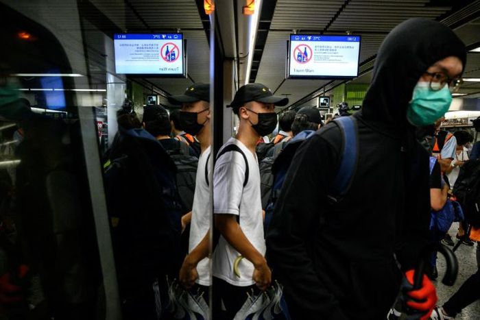 Protesters stood at doorways of trains, stopping them from closing, at a series of stations on the underground system