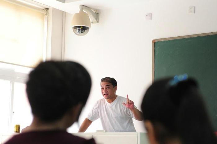 Ilham Tohti, a Uighur scholar imprisoned in China whom the European Parliament has put on its shortlist for the Sakharov Prize, lectures in a classroom in Beijing in 2010