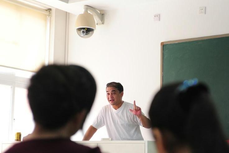 Ilham Tohti, a Uighur scholar imprisoned in China whom the European Parliament has put on its shortlist for the Sakharov Prize, lectures in a classroom in Beijing in 2010