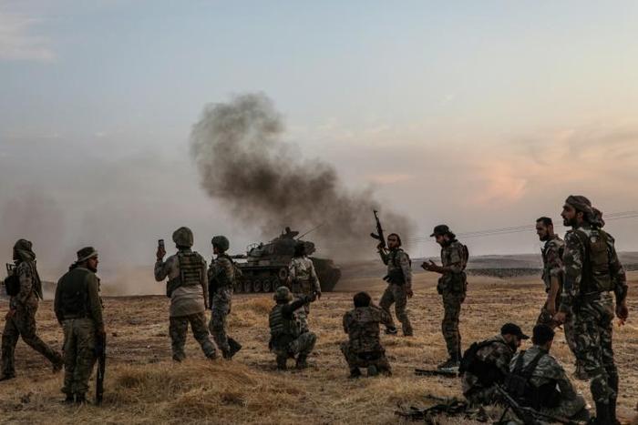 Turkish soldiers and Turkey-backed Syrian fighters on the outskirts of the Syrian city of Manbij near the Turkish border