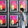 A woman walks past posters for the Busan International Film Festival at the Busan Cinema Center in South Korea