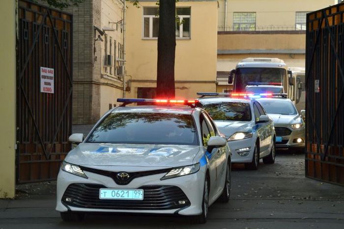 A police convoy escorts two buses with tinted windows from the high-security prison of Lefortovo in Moscow as a long-awaited exchange of prisoners between Moscow and Kiev gets underway