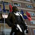 Kosovo and Albanian flags fly behind a statue of a former Kosovo Liberation Army commander in Pristina in 2014