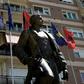 Kosovo and Albanian flags fly behind a statue of a former Kosovo Liberation Army commander in Pristina in 2014