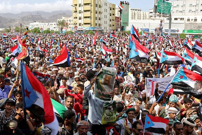 Supporters of separatists wave flags of the former South Yemen in the southern port city of Aden