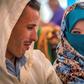A young Amazigh couple smile at each other as they wait for their turn at a group wedding in Morocco's Atlas mountains