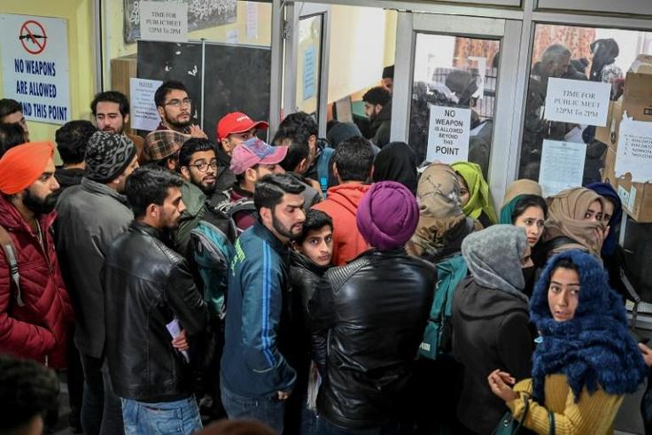 Kashmiri students wait for their turn to use the internet, with only around a dozen kiosks for the region's seven million inhabitants