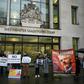 Supporters wave banners outside the London court where WikiLeaks founder Julian Assange was testifying about how he was spied on inside the Ecuadoran embassy