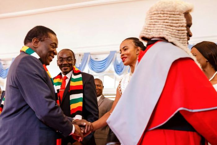 Better times: President Emmerson Mnangagwa, left, shakes hands with Marry Mubawaiafter a swearing-in ceremony for new vice presidents