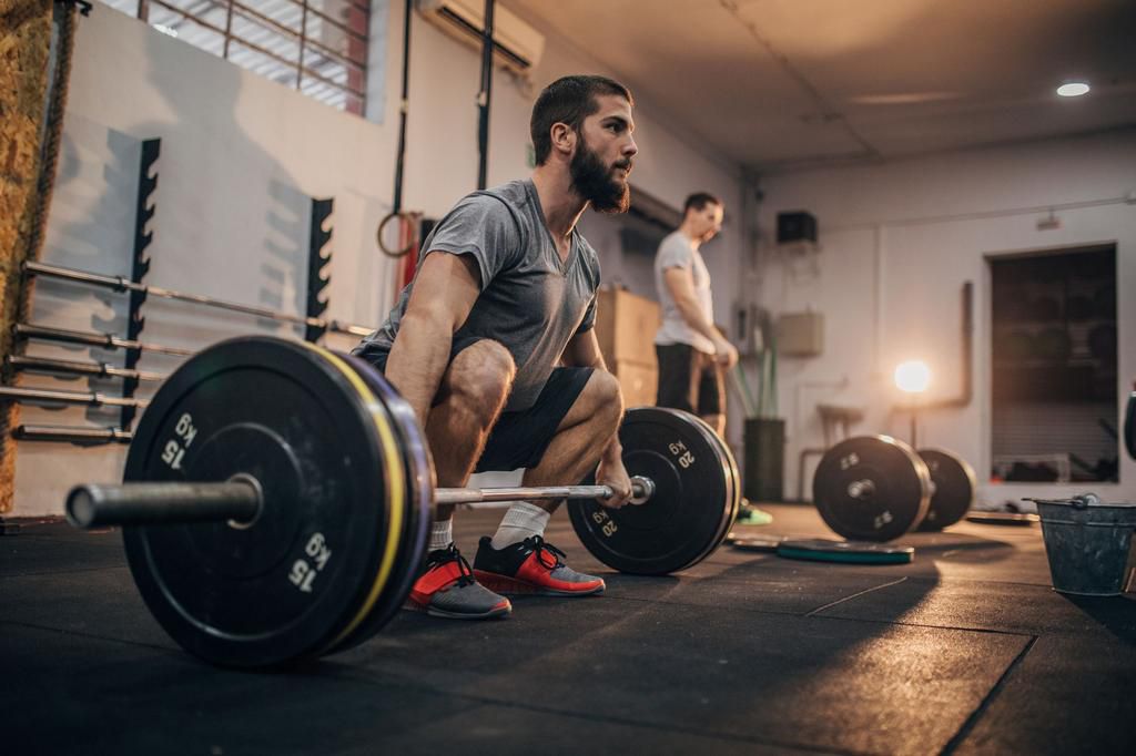 Man lifting barbell at the gym