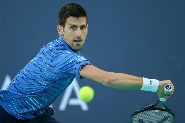 On the stretch: Novak Djokovic returns the ball to Karen Khachanov