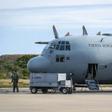 A man stands next to a C-130 plane that returned to Punta Arenas, Chile, from a search of the Drake Passage for a missing Air Force plane with 38 people aboard