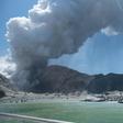 This handout photograph courtesy of Michael Schade shows the volcano on New Zealand's White Island spewing steam and ash minutes following a deadly eruption