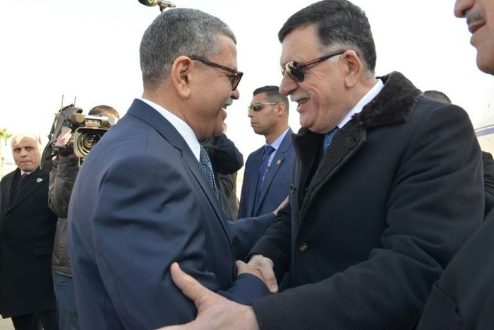 A handout picture released by the official Algeria Press Service (APS) on January 6, 2020 shows Algeria's Prime Minister Abdelaziz Djerad (L) receiving Libya's UN-recognised Prime Minister Fayez al-Sarraj upon his arrival in Algiers