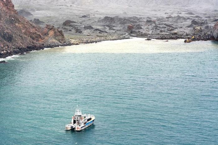 Divers searching the contaminated waters around New Zealand's volcanic White Island on Saturday failed to locate one body seen floating in the area several days ago