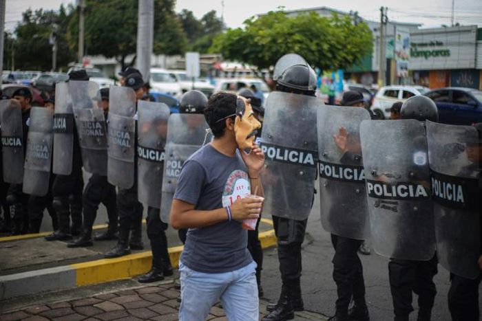 An anti-government protester wears a mask depicting Nicaraguan President Daniel Ortega on October 31, 2019
