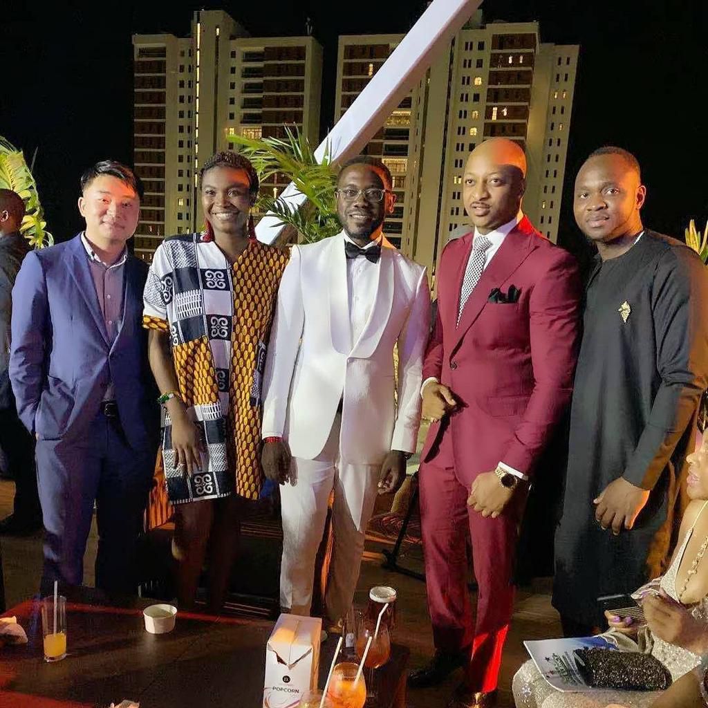 Deyemi Okanlawon (in white) and IK Ogbonna (in wine colour) attended the premiere of 'Your Excellency' with friends and colleagues. [Instagram]