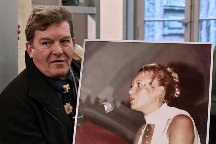 Jacky Kulik holds a portrait of his daughter Elodie who was kidnapped, raped, strangled and her corpse then burned in northern France in January 2002