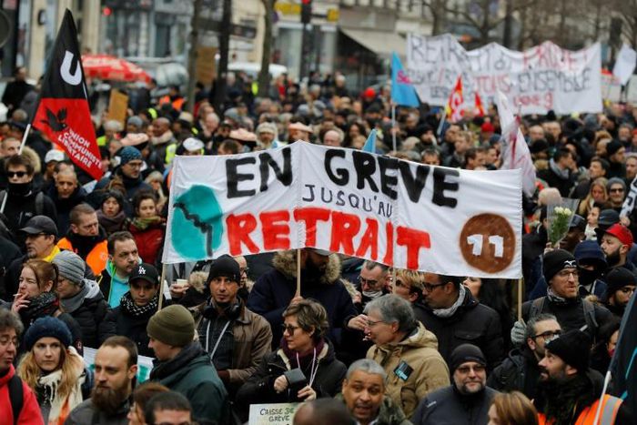 Thousands of people gathered to demonstrate in central Paris against pension reform a month into the protest -- their banner reads "on strike until withdrawal"