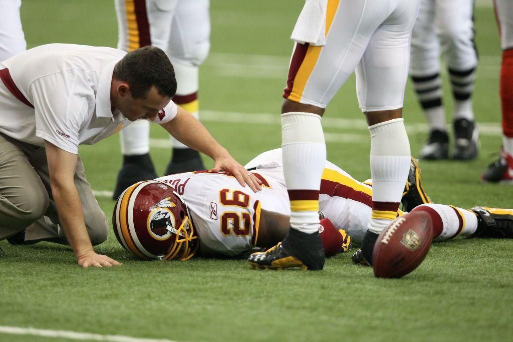 An NFL player on the turf after a hit that caused a concussion.