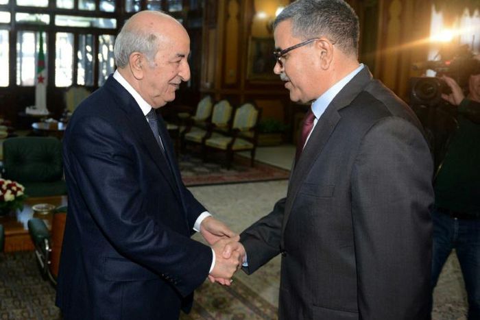 A handout picture released by the official Algeria Press Service (APS) shows Algerian President Abdelaziz Tebboune (L) receiving the newly appointed Prime Minister Abdelaziz Djerad in the capital Algiers on December 28, 2019