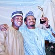 Senator Elisha Abbo (right) raises his "Beacon of Hope" award. "Beacon of Hope" was his campaign slogan before he was elected as the youngest senator in the 9th Senate. Weeks before his inauguration, he beat up and arrested a woman for telling him to c...
