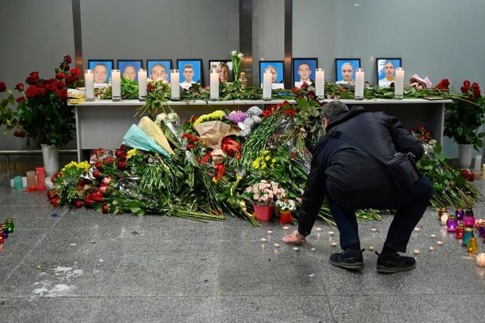 Dozens of people -- airline staff, passengers and locals alike -- gathered in the departure area to pay their respects to the crew, five men and four women