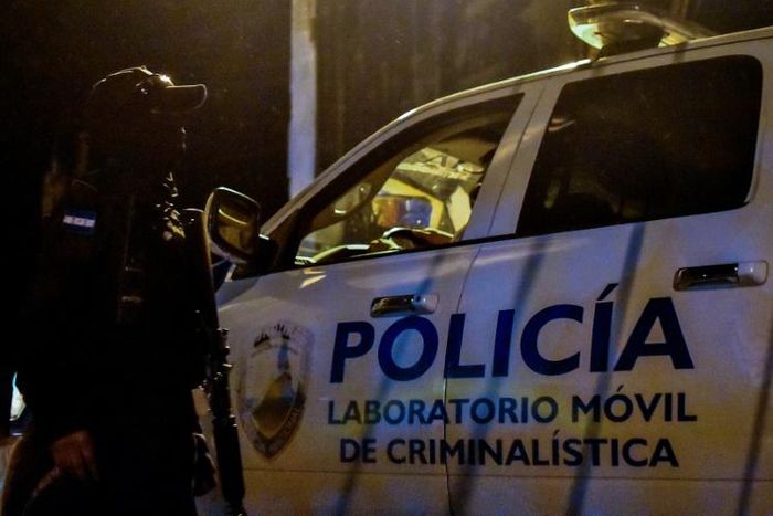 Forensic police arrive at the Tela prison in Honduras on December 21, 2019; officials said overnight fighting between rival gangs had claimed at least 18 lives