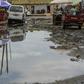 A large puddle of stagnant water sits in the roadway in a slum in Luanda, Angola in February 2018 following heavy rain