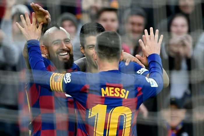 Arturo Vidal and Luis Suarez celebrate after Lionel Messi's goal