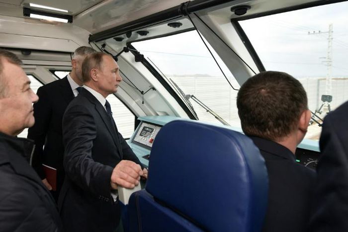 Russian President Vladimir Putin rides a train connecting the Crimea to mainland Russia