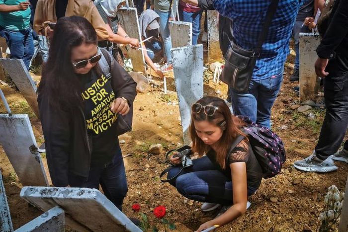 On the 10th anniversary, relatives visit the site of the massacre where markers represent the 58 victims of the November 23, 2009 killings